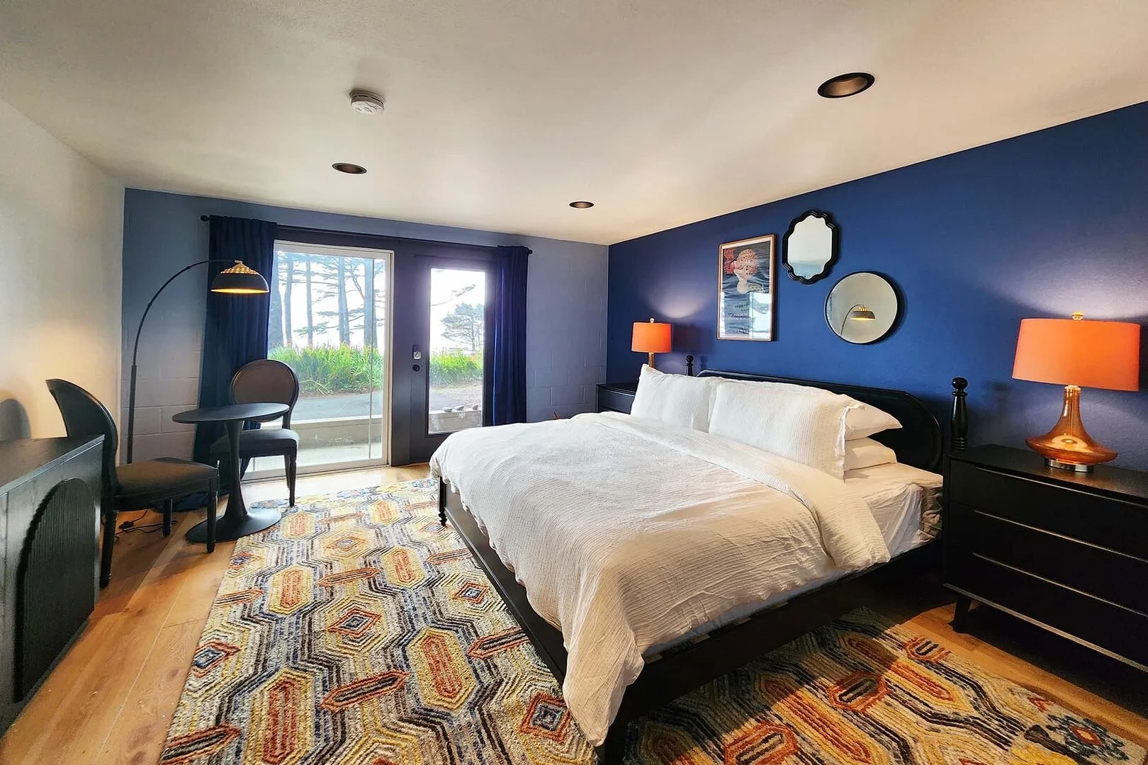 The Captain's Bounty bedroom with blue accent wall and orange lamps