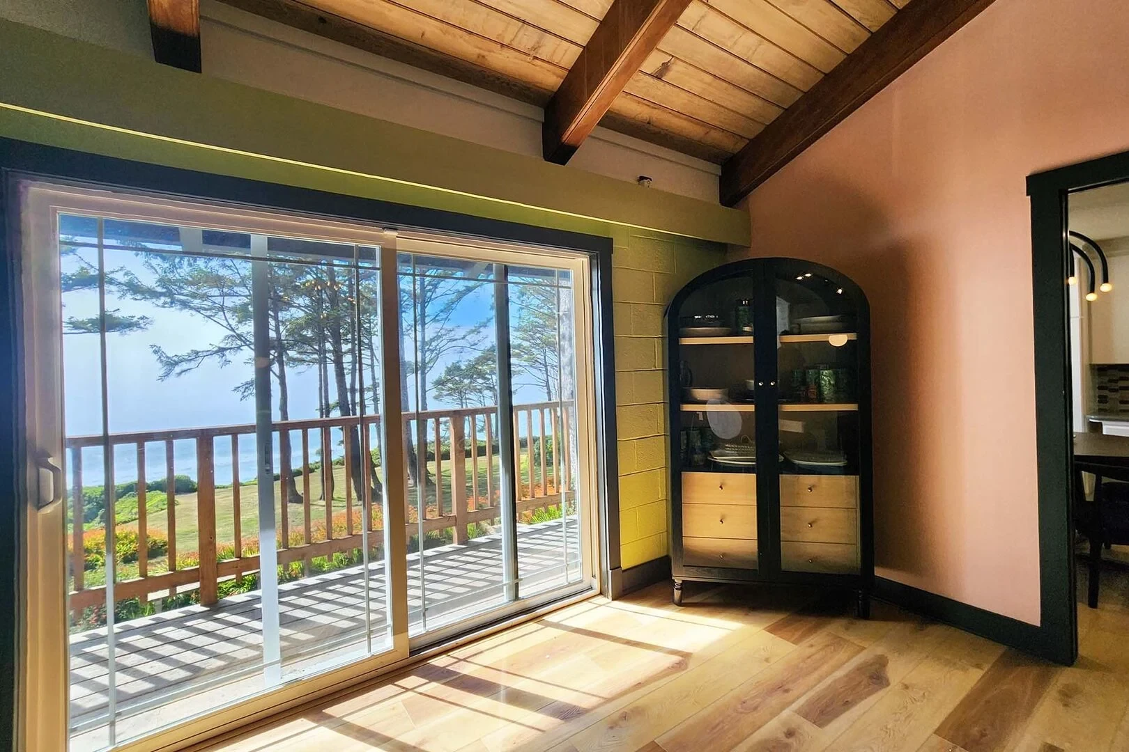 The Captain's Bounty interior with ocean view through sliding glass doors
