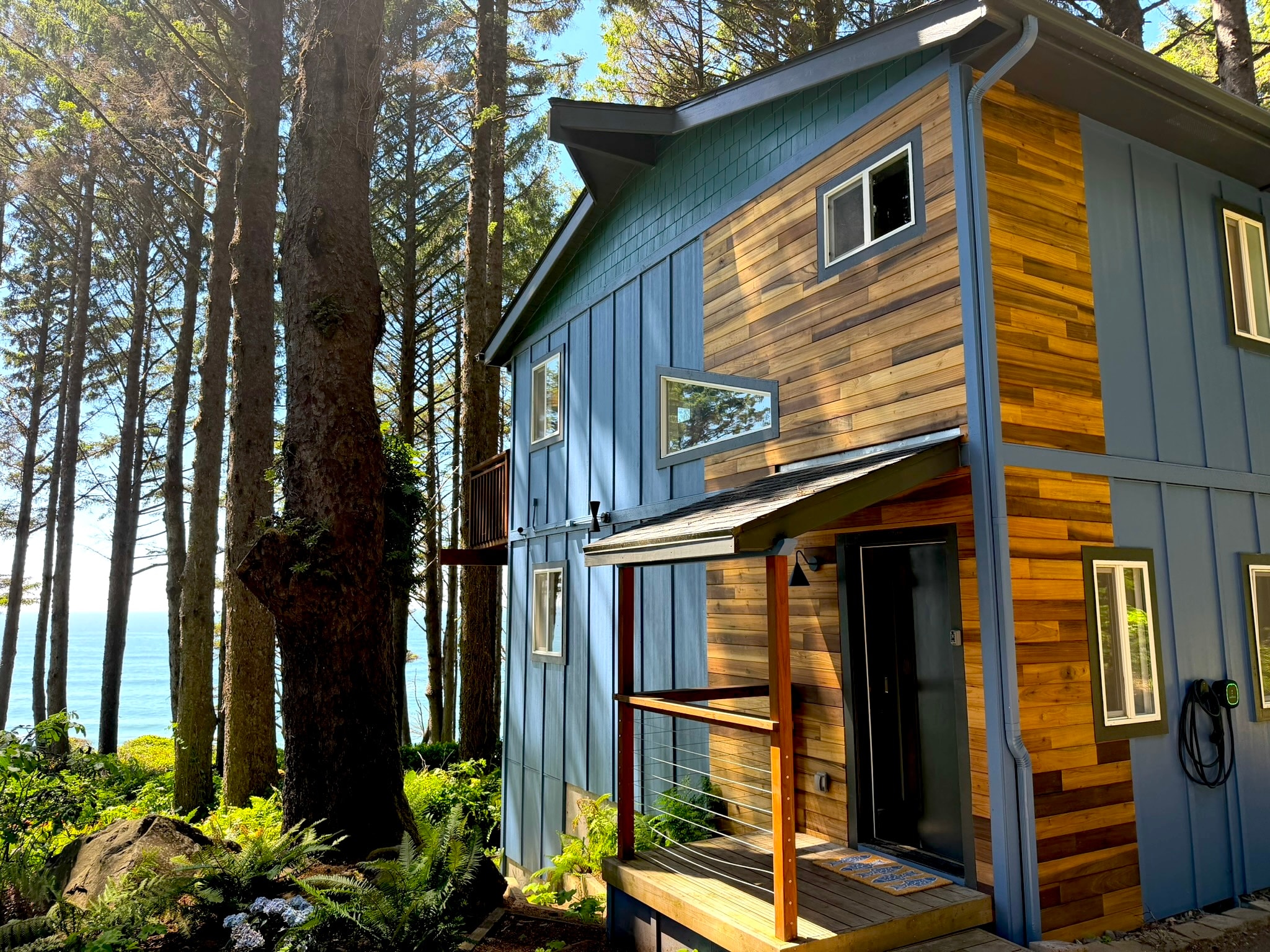 The Mighty Mussel exterior — blue siding and wood accents in the forest